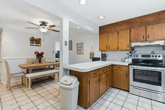 a kitchen with a stove a sink and a refrigerator