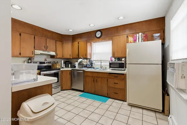 a kitchen with a refrigerator sink and cabinets