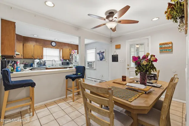 a kitchen with a table chairs refrigerator and cabinets