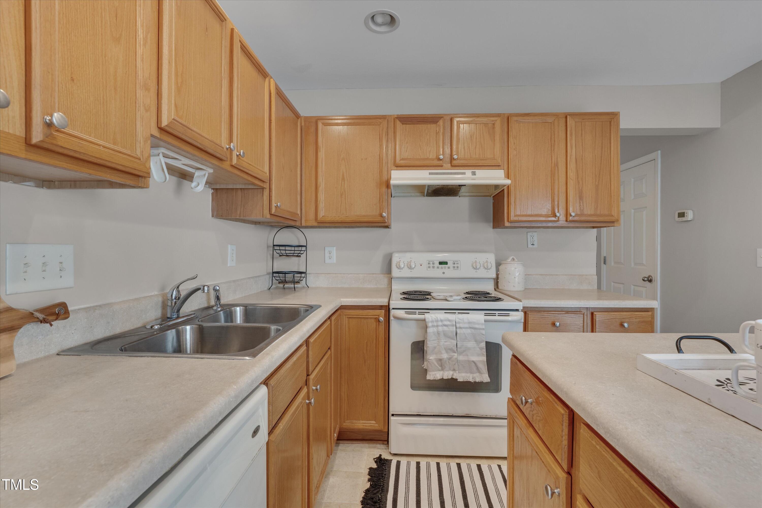 7704 Averette Field Drive Raleigh, NC 27616 - Photo 11 of 25 a kitchen with a sink stove and cabinets