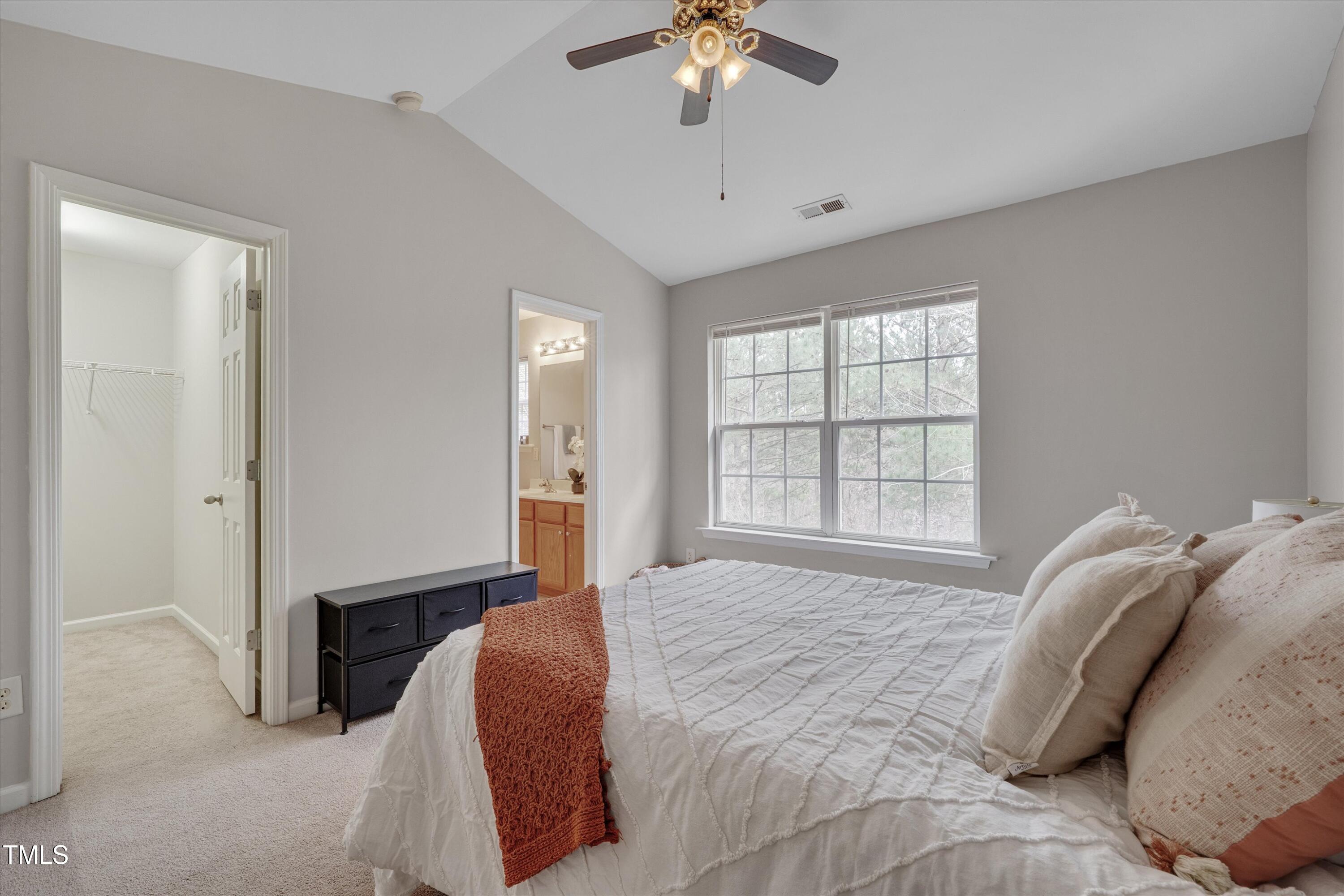 7704 Averette Field Drive Raleigh, NC 27616 - Photo 15 of 25 a spacious bedroom with a bed and a chandelier