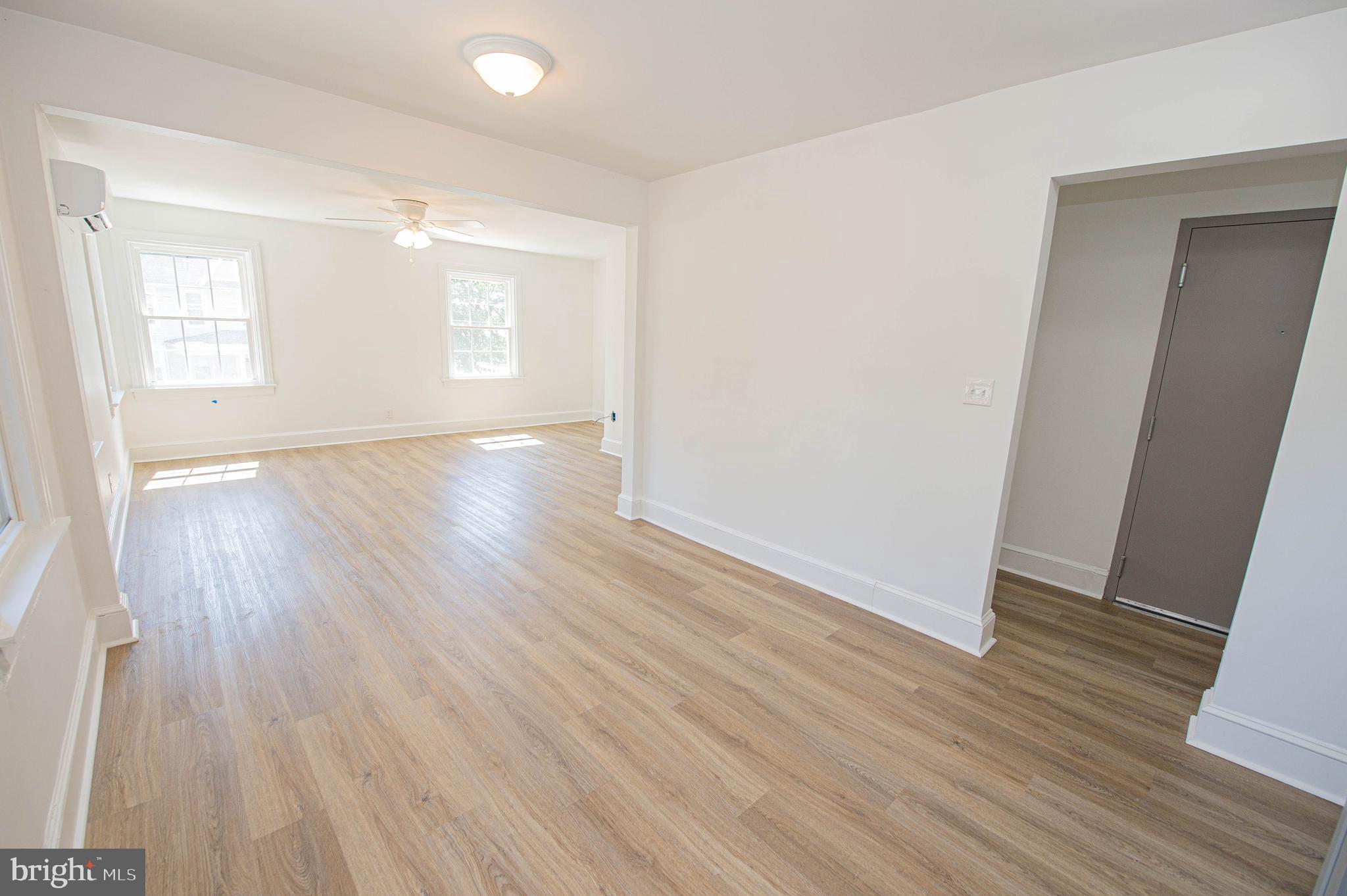 308 North Division Street, Unit 12 Salisbury, MD 21801 - Photo 12 of 42 an empty room with wooden floor and windows