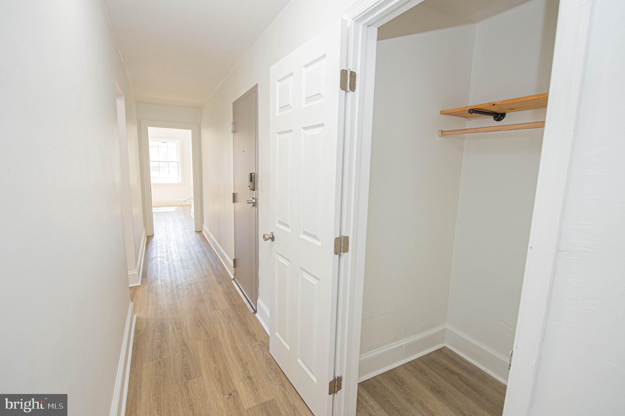 308 North Division Street, Unit 12 Salisbury, MD 21801 - Photo 16 of 42 a view of a hallway with wooden floor and staircase