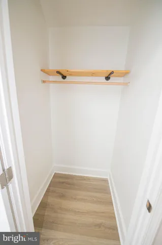 a view of a room with wooden floor