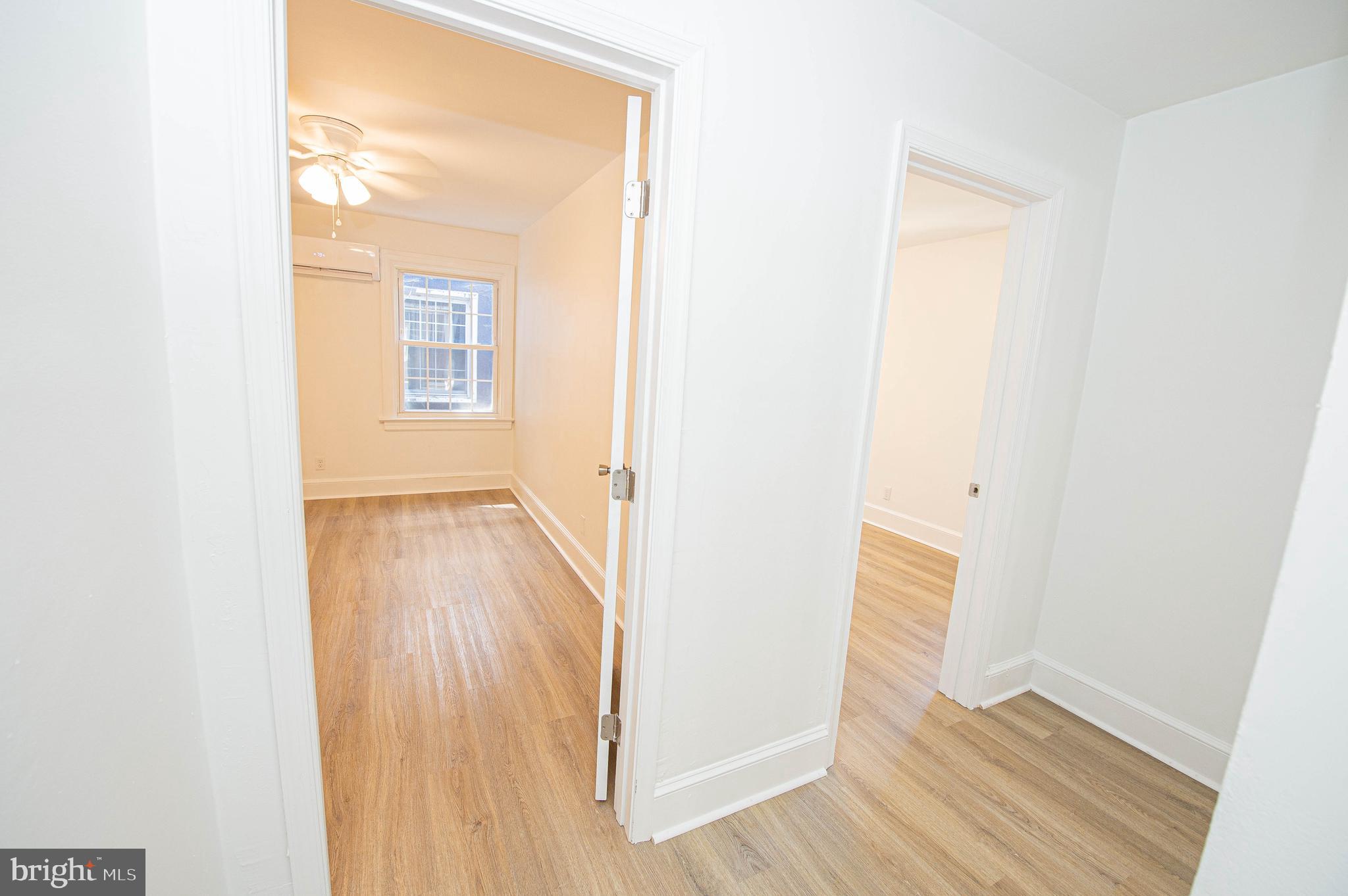 308 North Division Street, Unit 12 Salisbury, MD 21801 - Photo 18 of 42 a view of a hallway with wooden floor and a bathroom