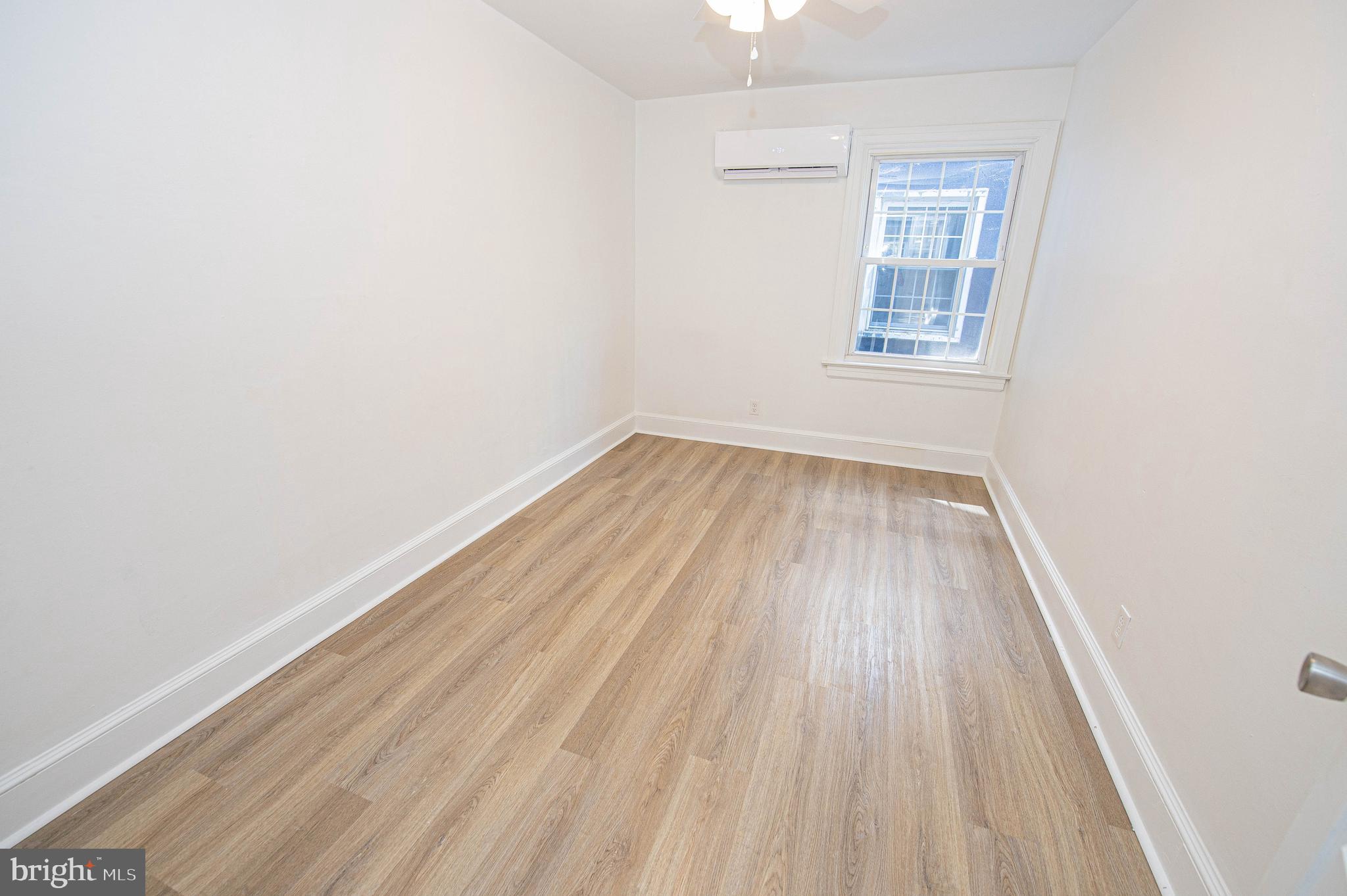 308 North Division Street, Unit 12 Salisbury, MD 21801 - Photo 20 of 42 an empty room with wooden floor and windows