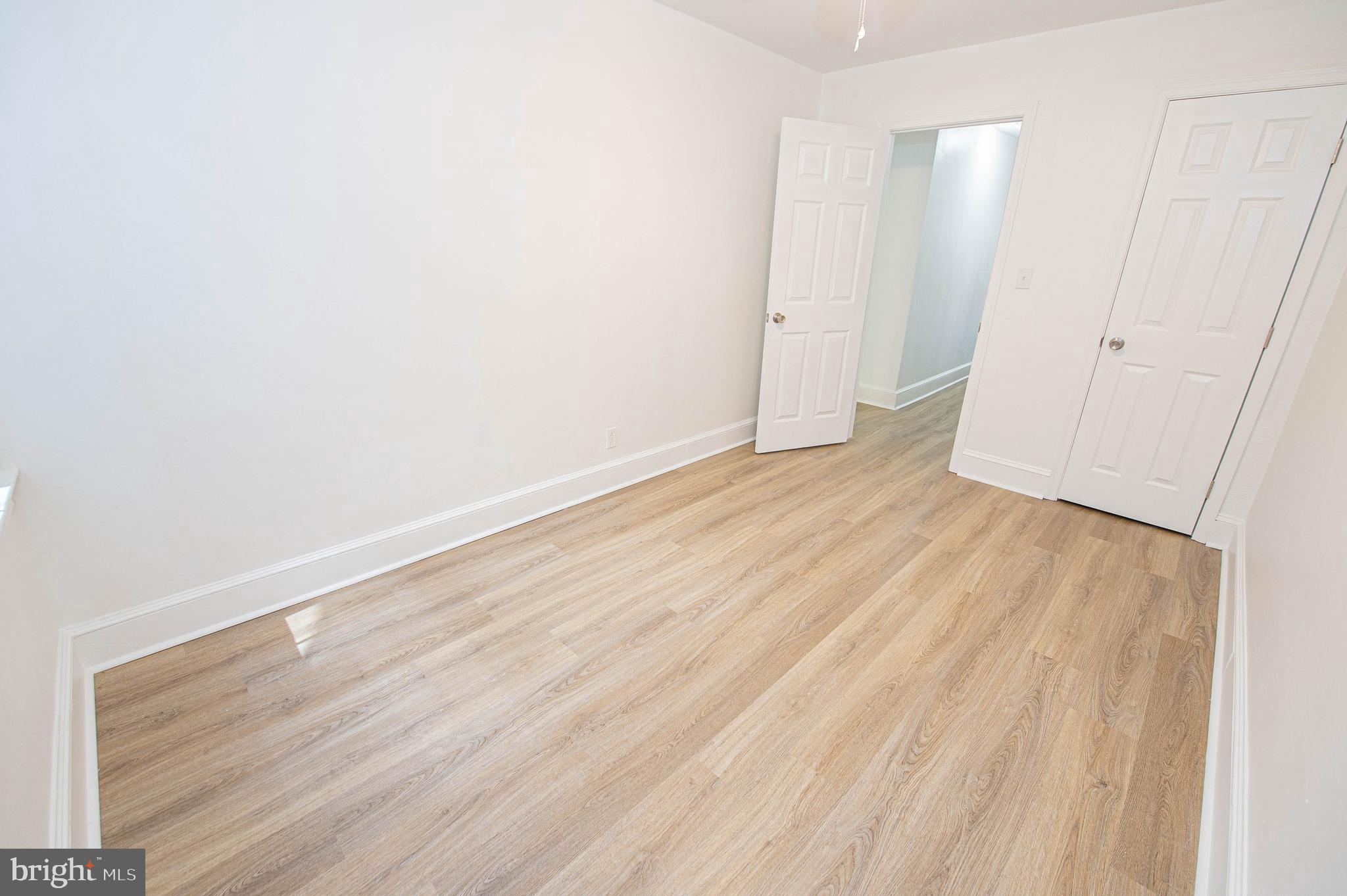 308 North Division Street, Unit 12 Salisbury, MD 21801 - Photo 21 of 42 a view of an empty room with wooden floor