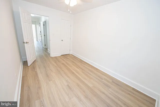 an empty room with wooden floor and a window