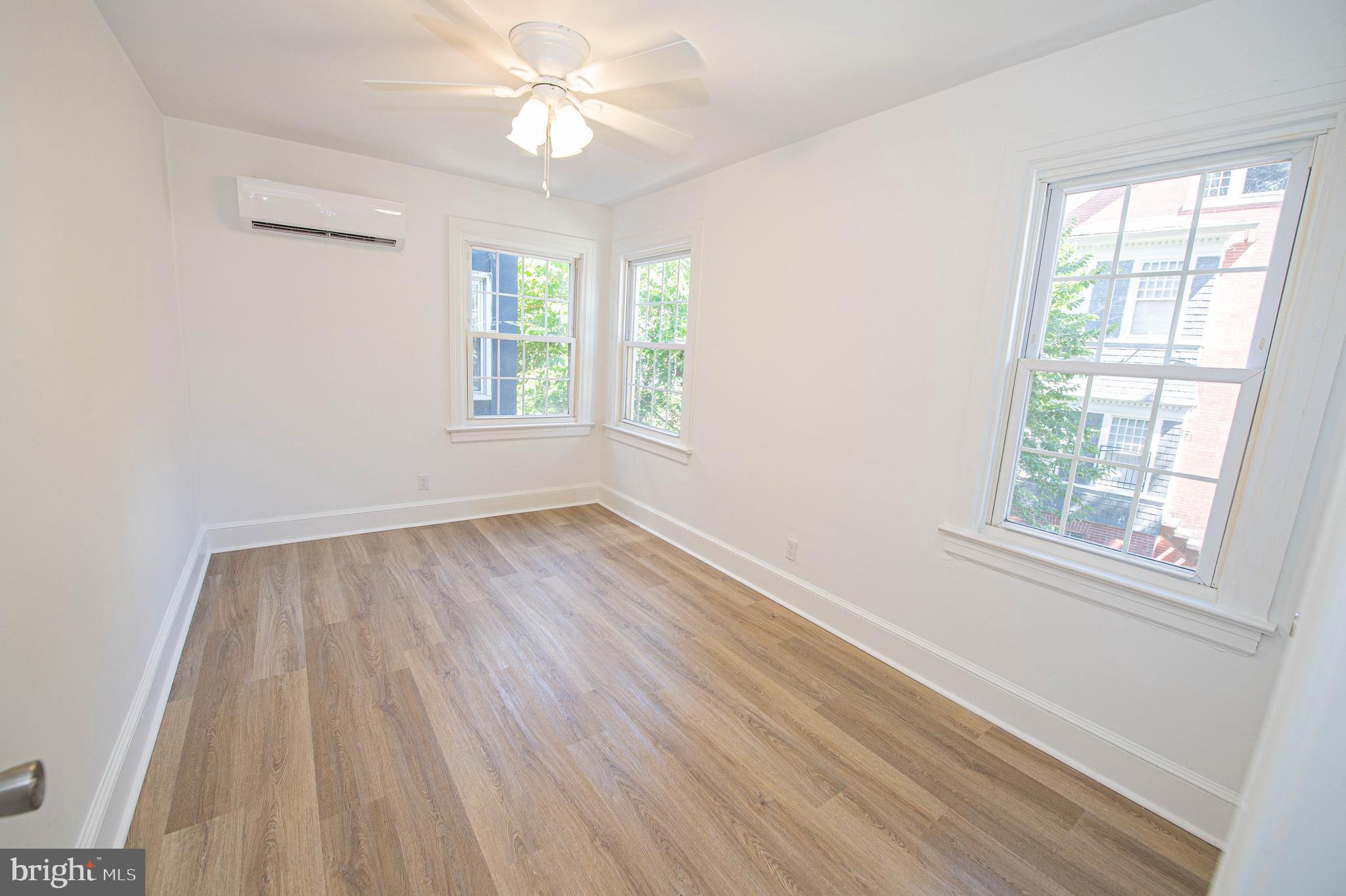 308 North Division Street, Unit 12 Salisbury, MD 21801 - Photo 26 of 42 wooden floor in an empty room with a window