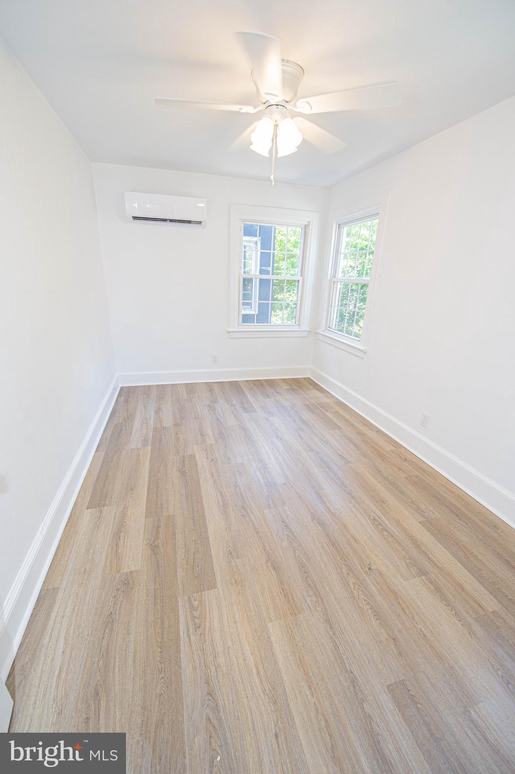 308 North Division Street, Unit 12 Salisbury, MD 21801 - Photo 27 of 42 wooden floor in an empty room with a window