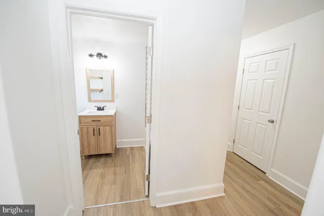 a view of bathroom with mirror on the wall