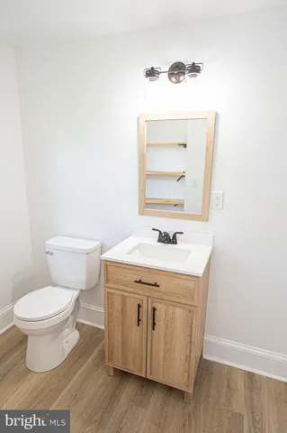 a bathroom with a sink a toilet and mirror