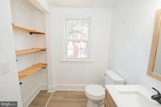 a white toilet sitting next to a bathroom sink and tub