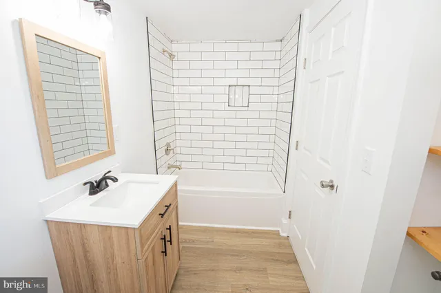 a bathroom with a sink a mirror and a shower