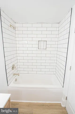 a bathroom with a bathtub and shower