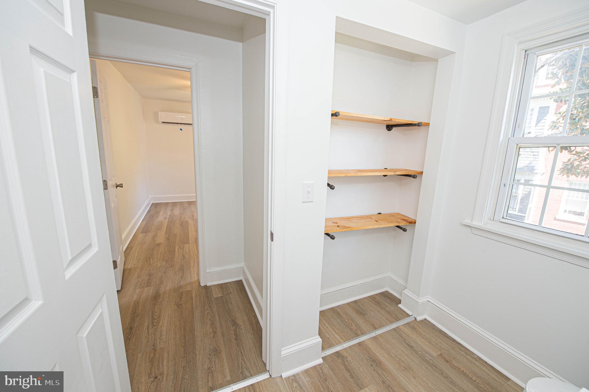 308 North Division Street, Unit 12 Salisbury, MD 21801 - Photo 39 of 42 a view of walk in closet with wooden floor