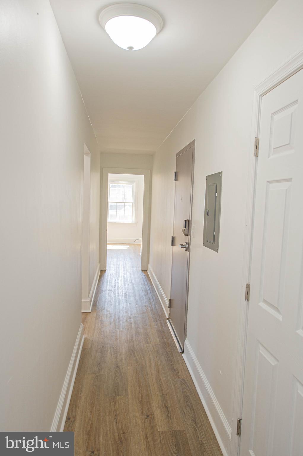 308 North Division Street, Unit 12 Salisbury, MD 21801 - Photo 5 of 42 a view of a hallway with wooden floor and a bathroom