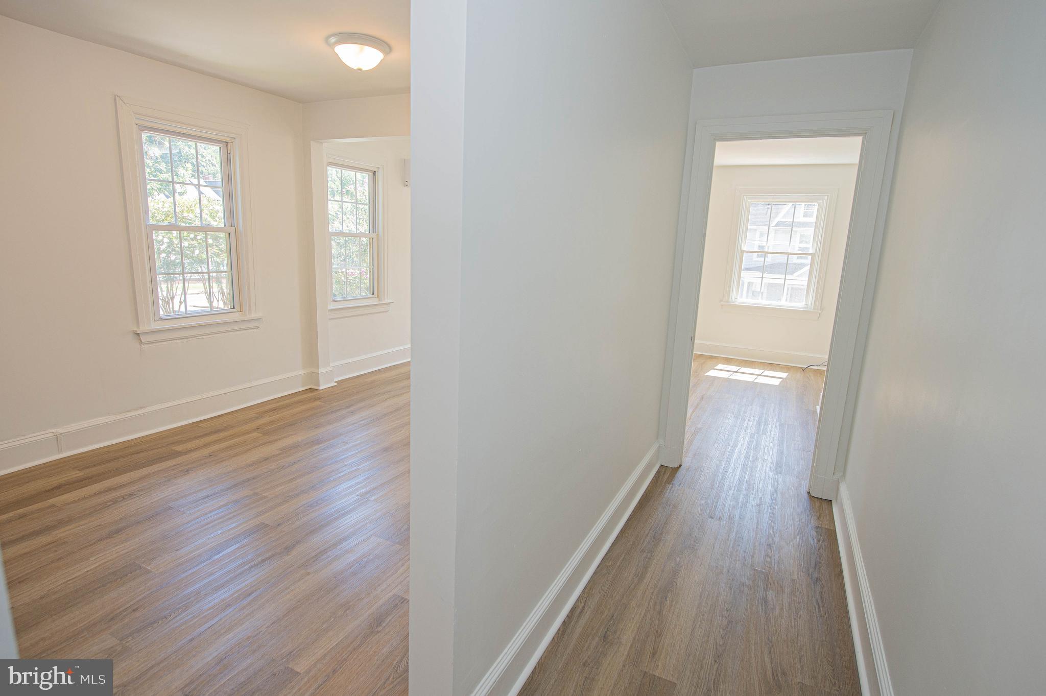 308 North Division Street, Unit 12 Salisbury, MD 21801 - Photo 8 of 42 wooden floor in an empty room with a window