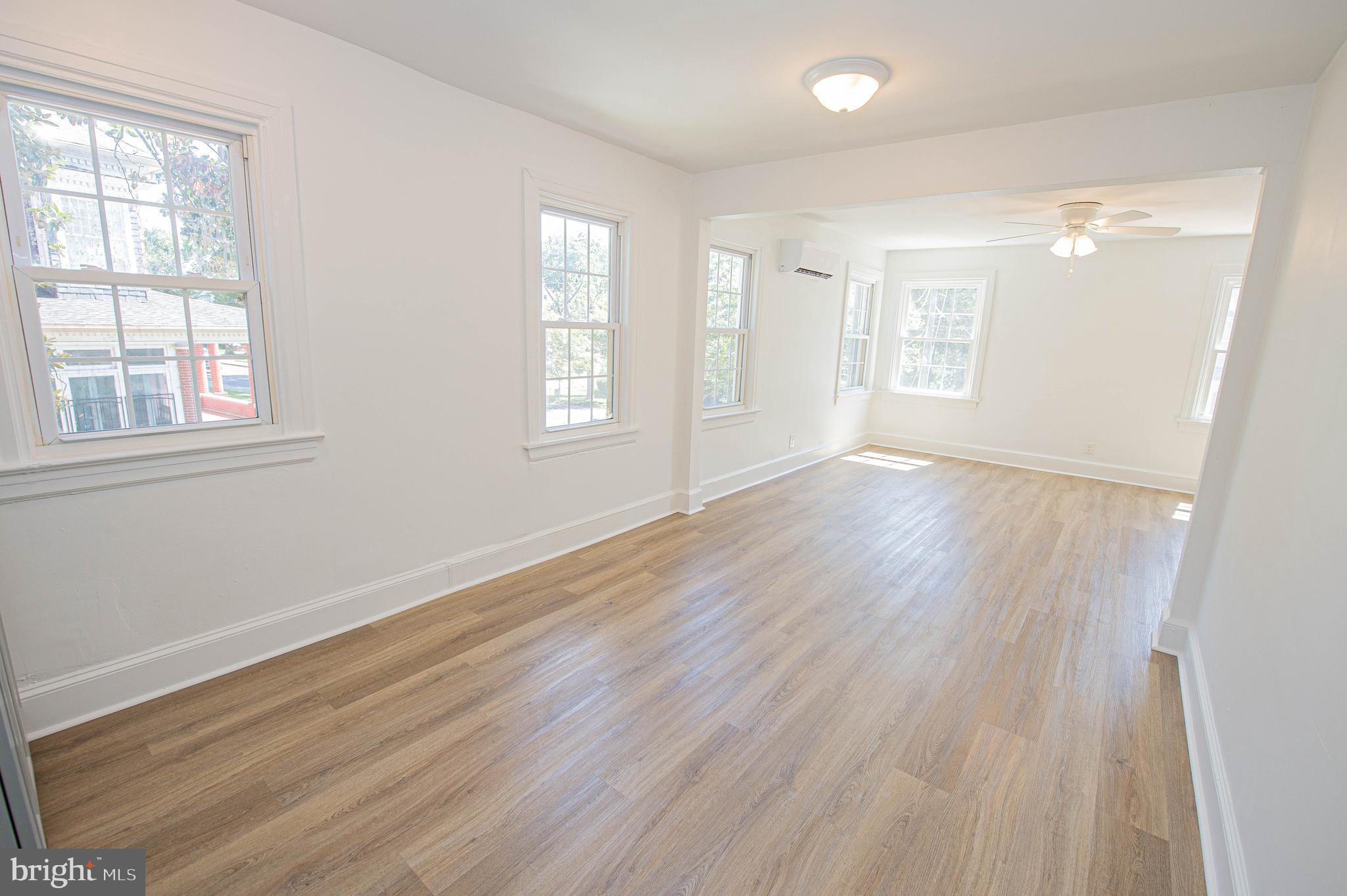 308 North Division Street, Unit 12 Salisbury, MD 21801 - Photo 9 of 42 an empty room with wooden floor and windows
