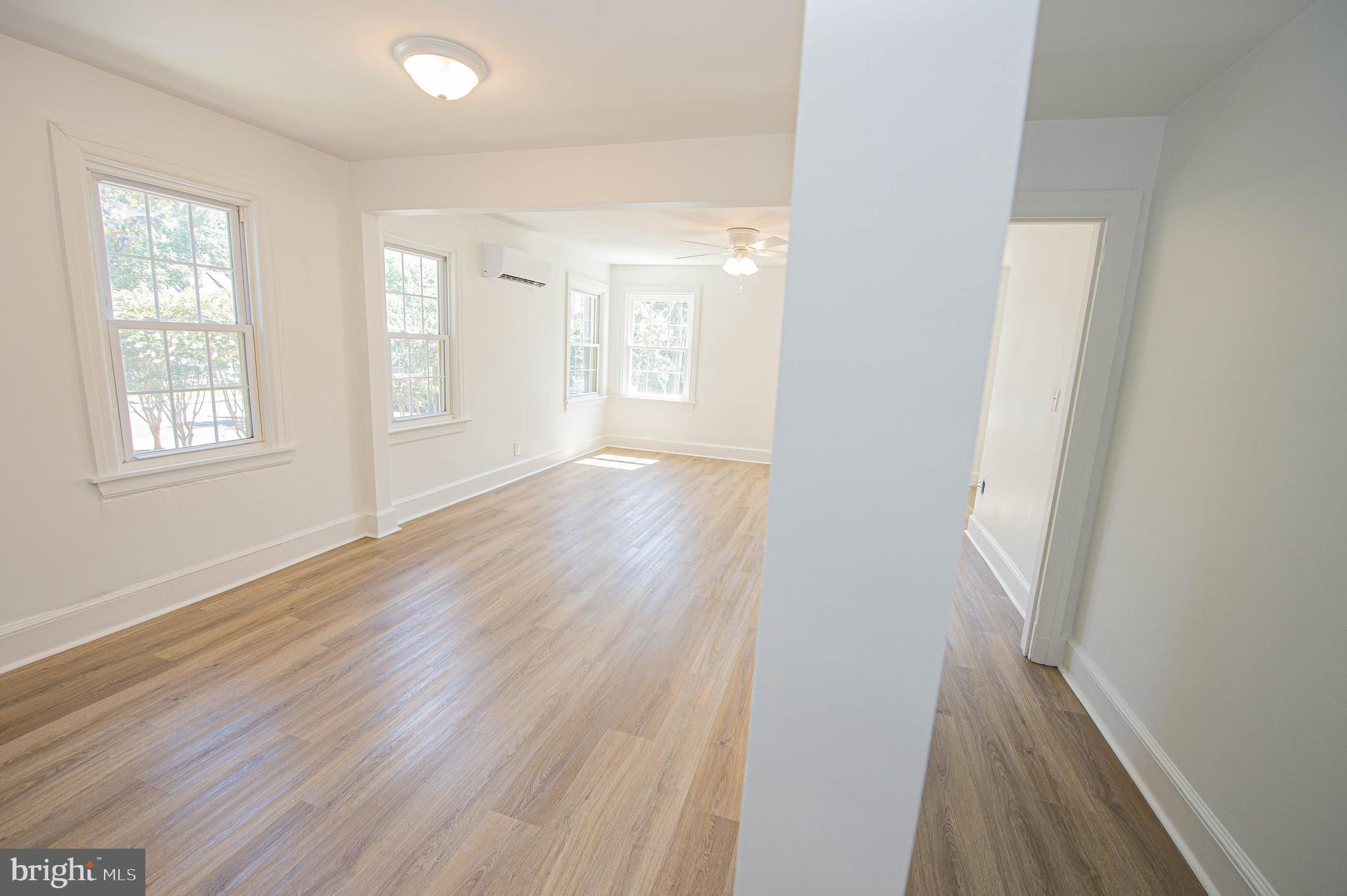 308 North Division Street, Unit 12 Salisbury, MD 21801 - Photo 10 of 42 an empty room with wooden floor and windows