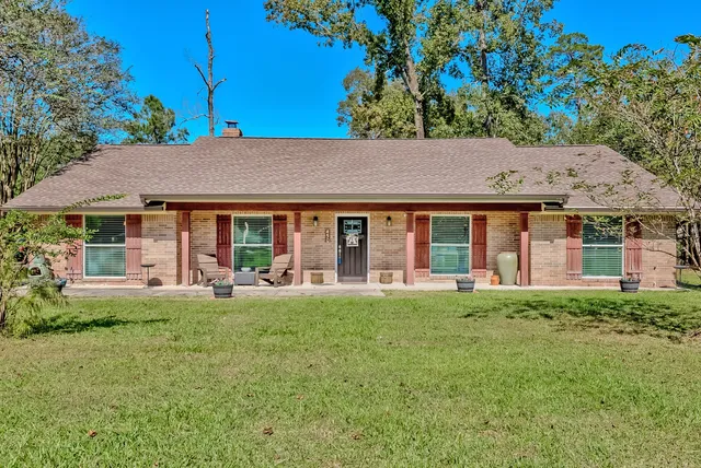 a front view of a house with a garden and porch