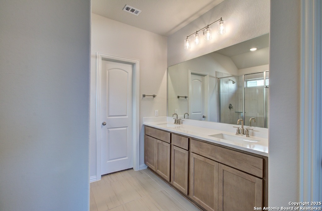 2133 Shepards Street Seguin, TX 78155 - Photo 15 of 22 a bathroom with a double vanity sink and mirror