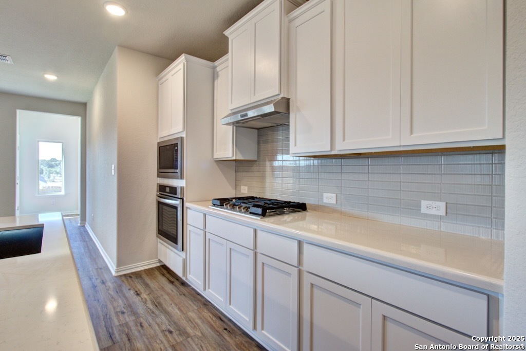 2133 Shepards Street Seguin, TX 78155 - Photo 3 of 22 a kitchen with granite countertop a sink a stove and refrigerator