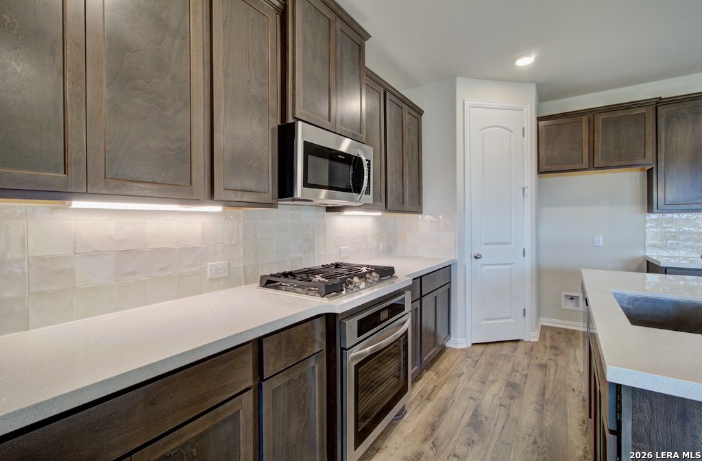 2133 Shepards Street Seguin, TX 78155 - Photo 4 of 21 a kitchen with stainless steel appliances a stove a sink and a microwave