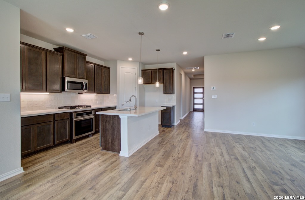 2133 Shepards Street Seguin, TX 78155 - Photo 5 of 21 a large kitchen with stainless steel appliances granite countertop a large counter top a stove a sink and a refrigerator