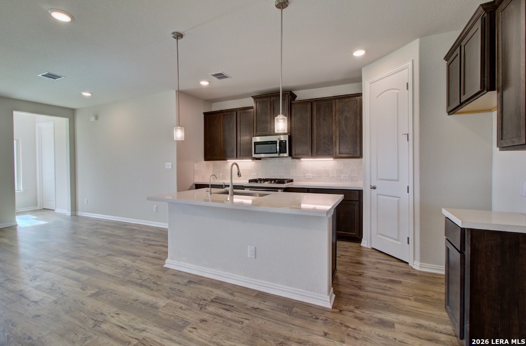 2133 Shepards Street Seguin, TX 78155 - Photo 7 of 21 a view of kitchen with stainless steel appliances granite countertop cabinets and wooden floor