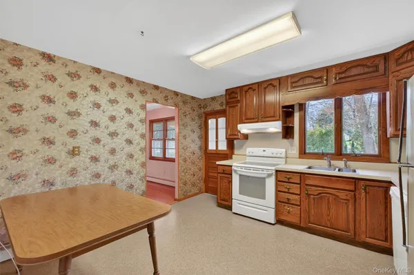 a kitchen with stainless steel appliances a stove a sink and a refrigerator