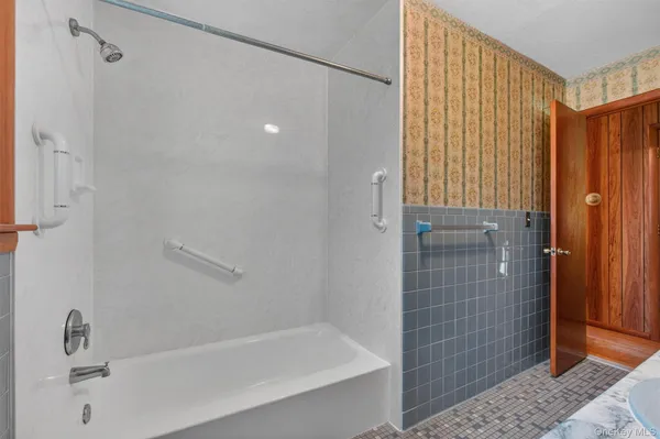 a bathroom with a shower and a tub