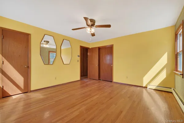 a view of a room with wooden floor and windows