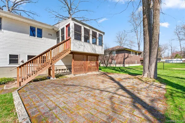 a view of a house with a big yard and potted plants