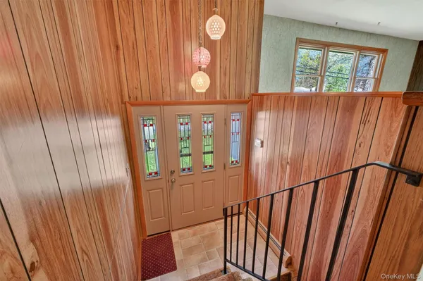 a view of an entryway with wooden floor