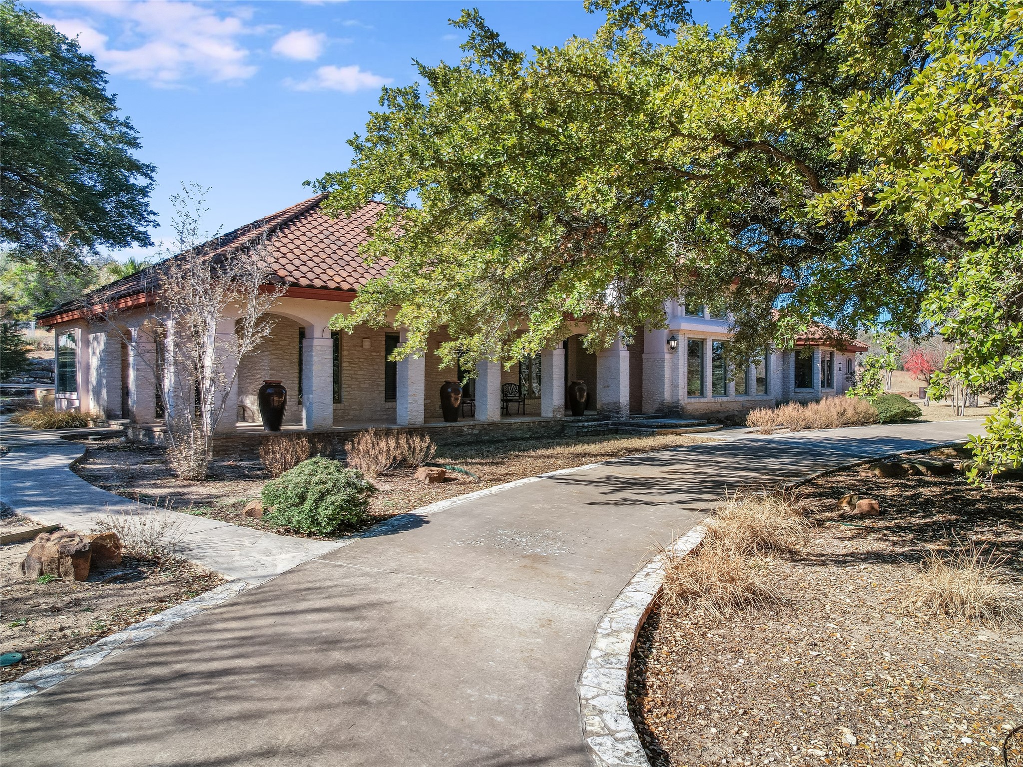 25909 Hamilton Pool Road Round Mountain, TX 78663 - Photo 18 of 34 a front view of a house with a yard