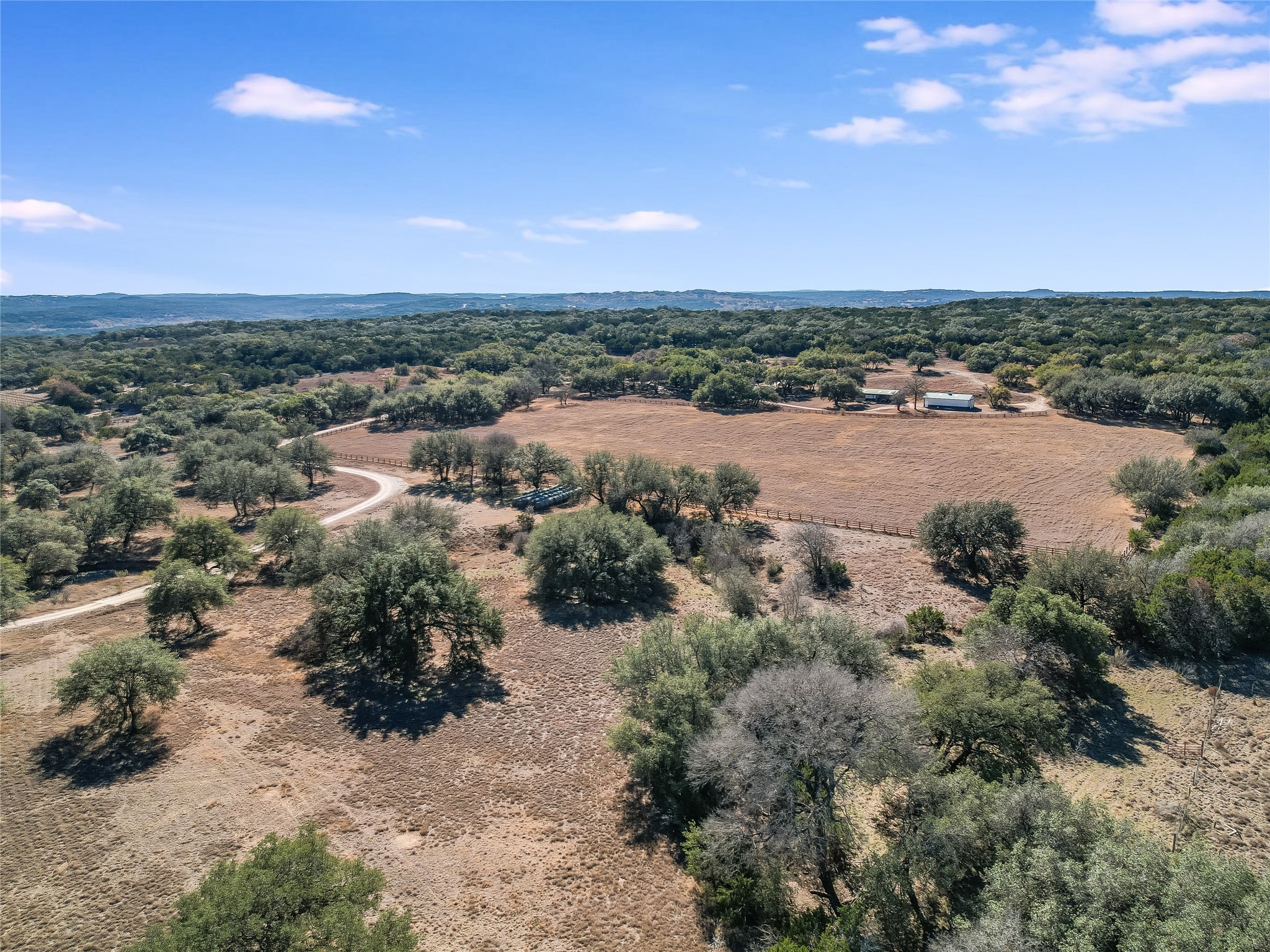25909 Hamilton Pool Road Round Mountain, TX 78663 - Photo 24 of 34 an aerial view of a houses with a lake view