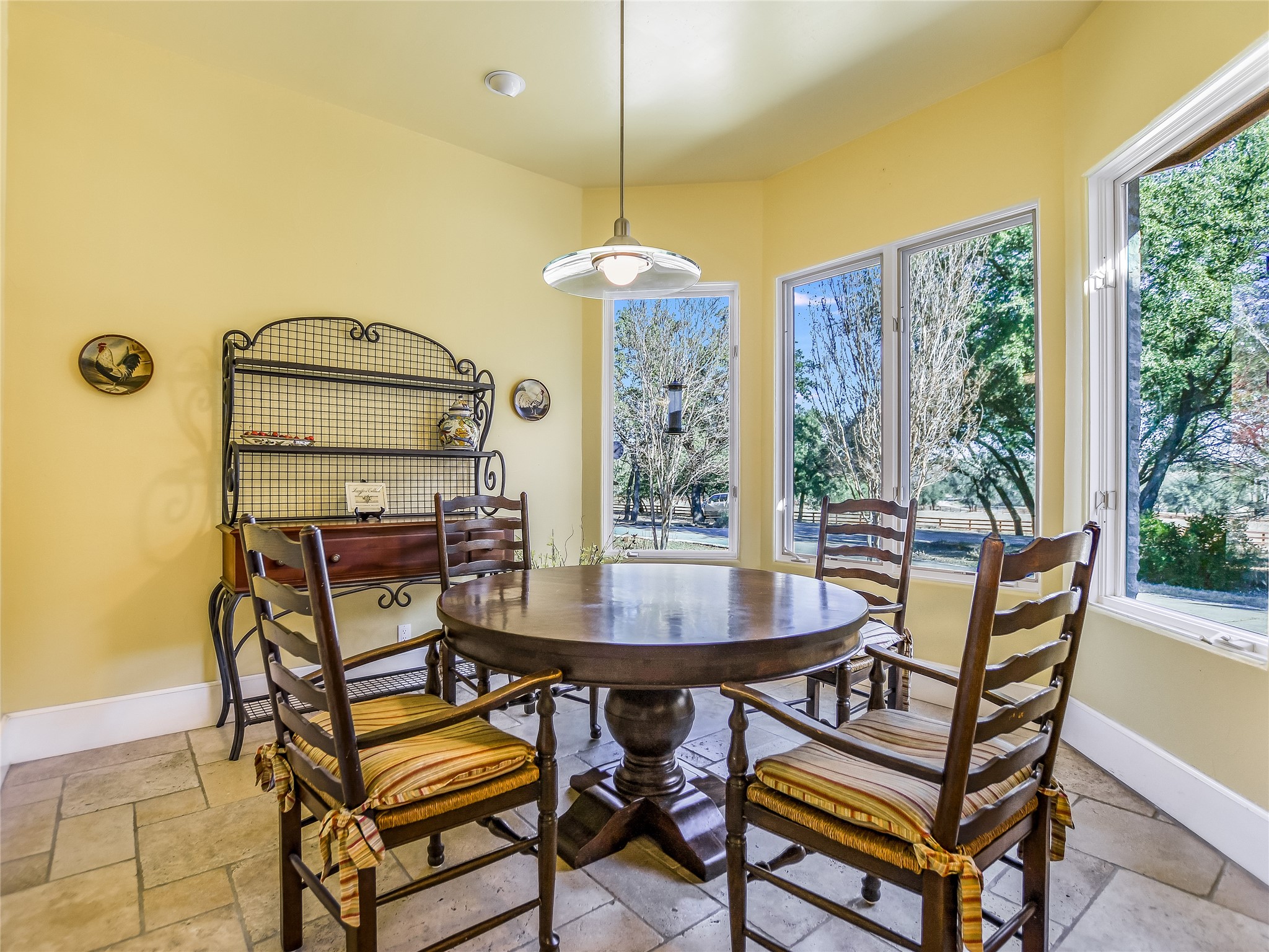25909 Hamilton Pool Road Round Mountain, TX 78663 - Photo 6 of 34 a dining room with furniture a chandelier and wooden floor