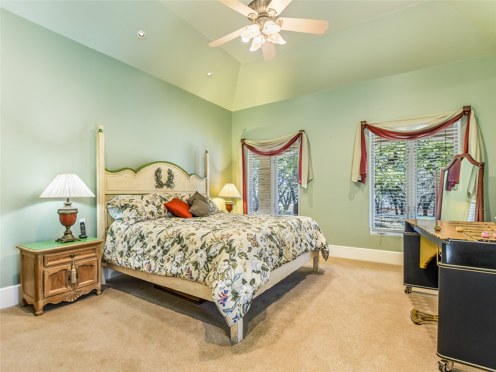 25909 Hamilton Pool Road Round Mountain, TX 78663 - Photo 9 of 34 a bedroom with a bed and a chandelier