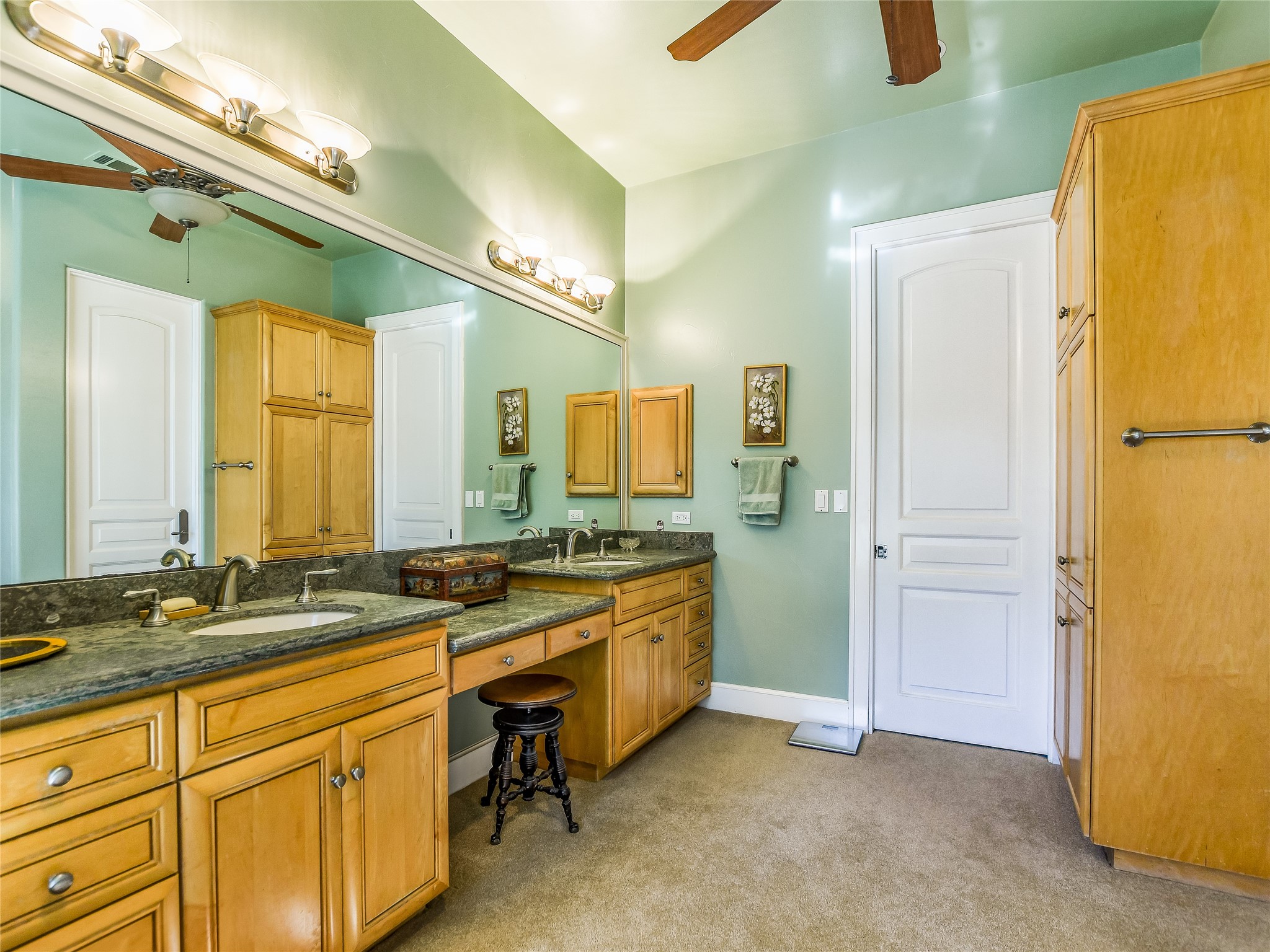 25909 Hamilton Pool Road Round Mountain, TX 78663 - Photo 10 of 34 a spacious bathroom with a granite countertop sink and a mirror