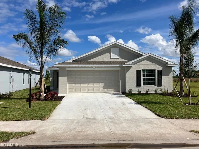 a front view of a house with a yard and garage