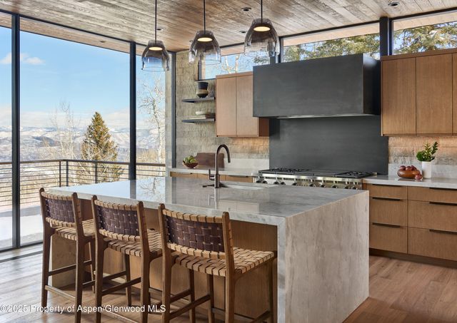 a view of kitchen and dining area with chandelier
