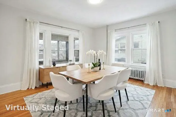 a view of a dining room with furniture window and wooden floor