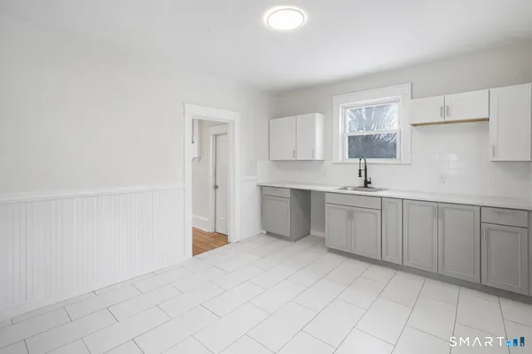 a kitchen with white cabinets