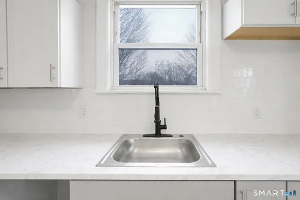 a kitchen with a sink and a window