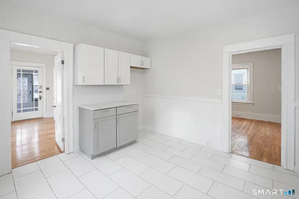 a view of a kitchen with white cabinets and a stove
