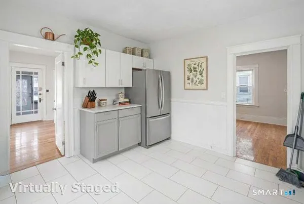 a kitchen with a refrigerator sink and cabinets