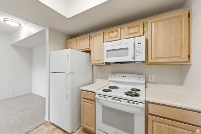 900 Bitner Road, Unit P20 Park City, UT 84098 - Photo 14 of 42 Kitchen featuring light wood cabinetry, white appliances, solid surface countertops, and tile flooring