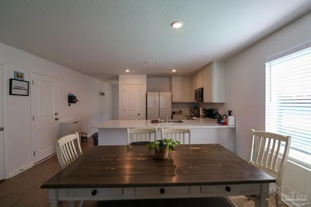 a kitchen with kitchen island granite countertop a stove a table and chairs