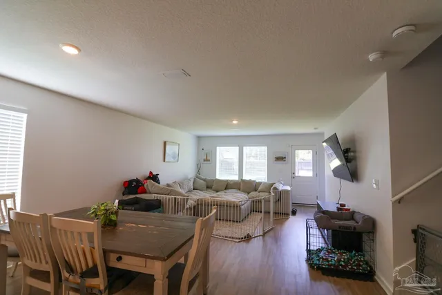 a living room with furniture a wooden floor and a fireplace